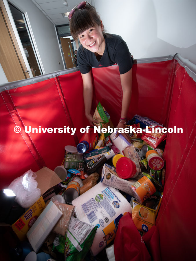 Justina Clark, Director of Undergraduate Research delivers donated items to the Husker Pantry. Her basket of products came from students in the Nebraska Summer Research Program The pantry and Money Management Center have moved from the Nebraska Union to the University Health Center. August 8, 2019, Photo by Gregory Nathan / University Communication.